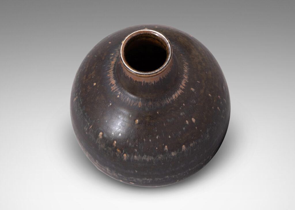 Gallery BAC globe form with flared base and tapered neck, glazed in black and red luster