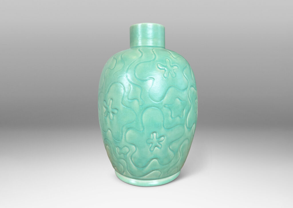 Gallery BAC large ovoid form with cheerful carved floral design, glazed in a bright celadon