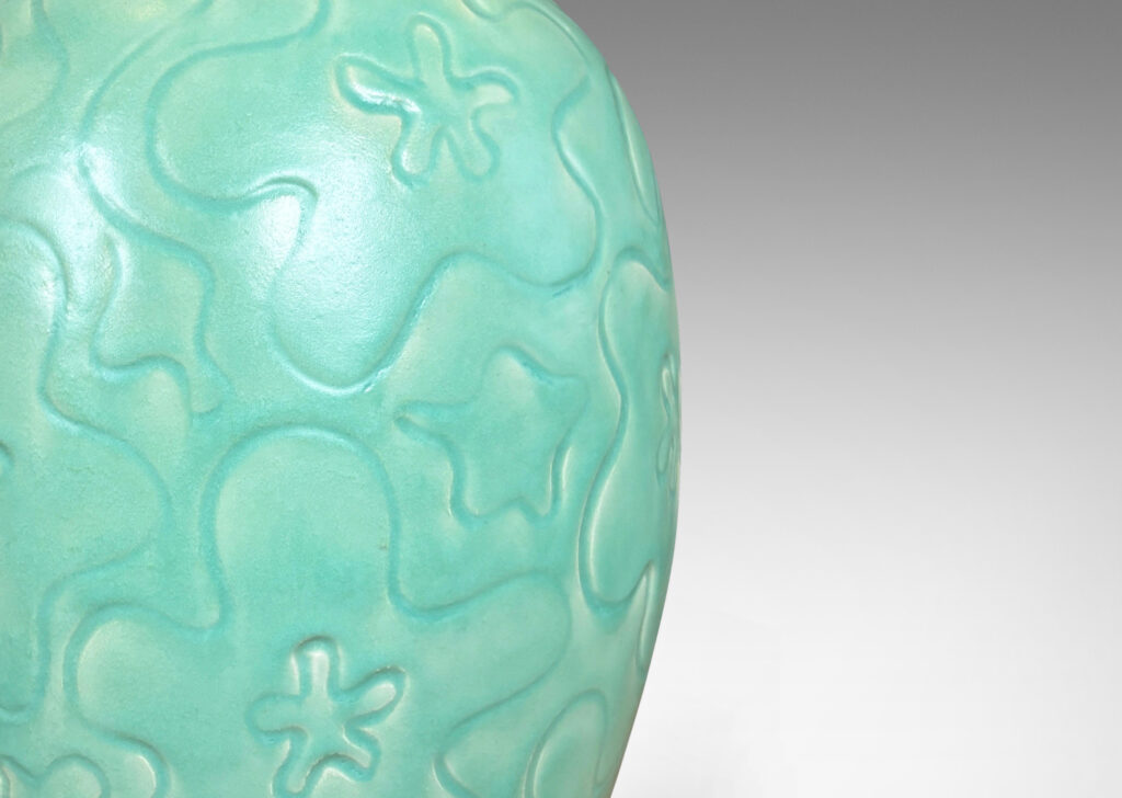 Gallery BAC large ovoid form with cheerful carved floral design, glazed in a bright celadon