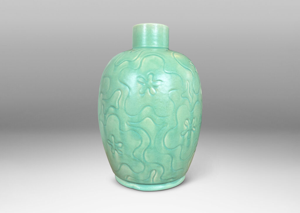 Gallery BAC large ovoid form with cheerful carved floral design, glazed in a bright celadon