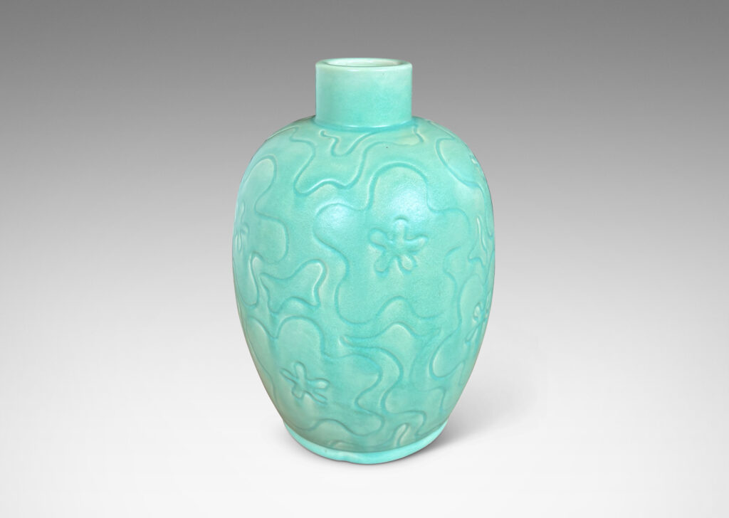 Gallery BAC large ovoid form with cheerful carved floral design, glazed in a bright celadon