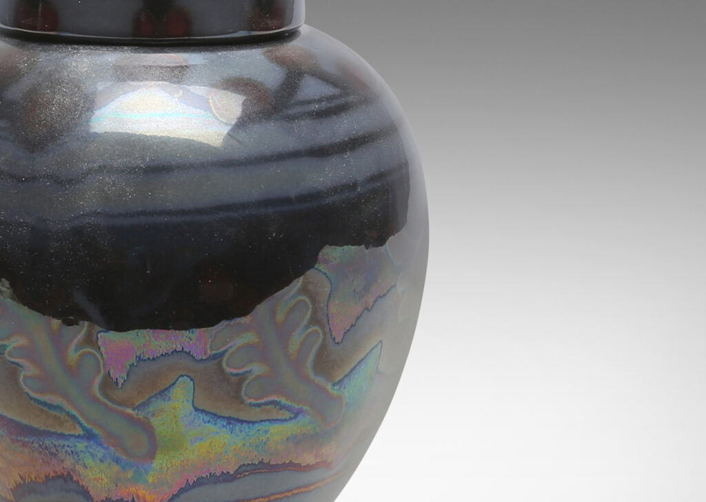 Gallery BAC tapered globe body with dome lid and ball finial, glazed in gray, purple and burgundy luster