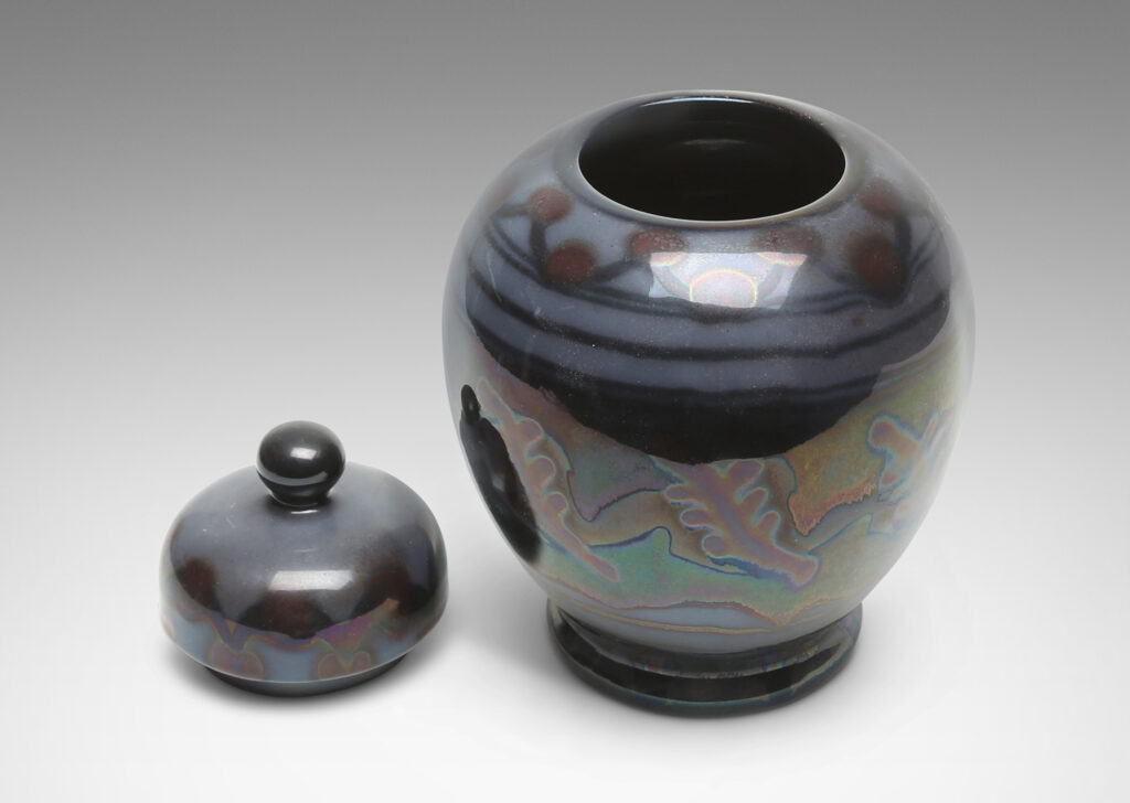 Gallery BAC tapered globe body with dome lid and ball finial, glazed in gray, purple and burgundy luster