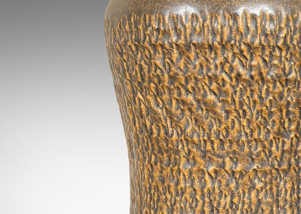 Gallery BAC sinuously modeled profile with carved texture and brown glaze