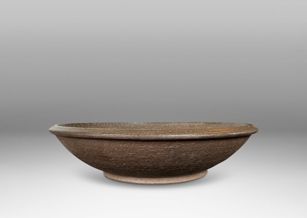Gallery BAC wide round form with a matte brown unglazed grog textured exterior, and eggshell brown glazed interior