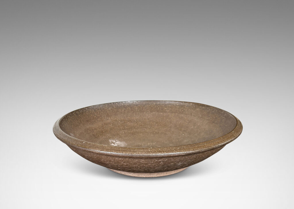 Gallery BAC wide round form with a matte brown unglazed grog textured exterior, and eggshell brown glazed interior