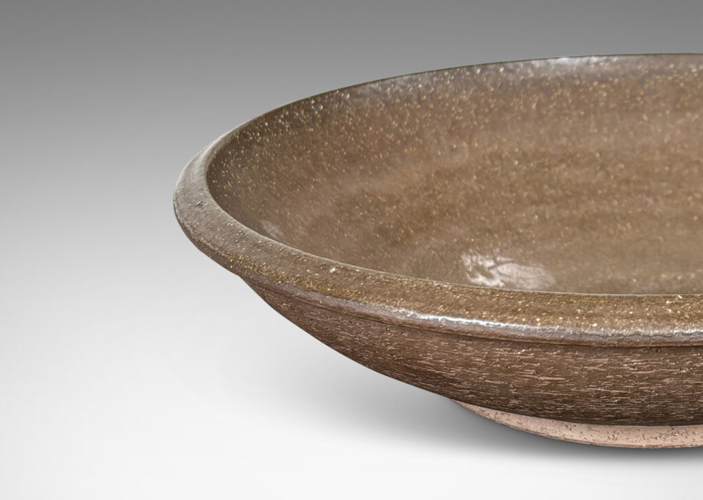 Gallery BAC wide round form with a matte brown unglazed grog textured exterior, and eggshell brown glazed interior