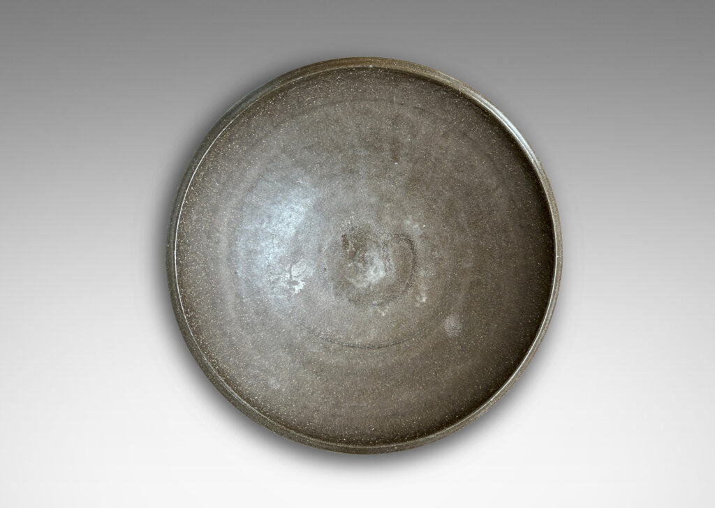 Gallery BAC wide round form with a matte brown unglazed grog textured exterior, and eggshell brown glazed interior
