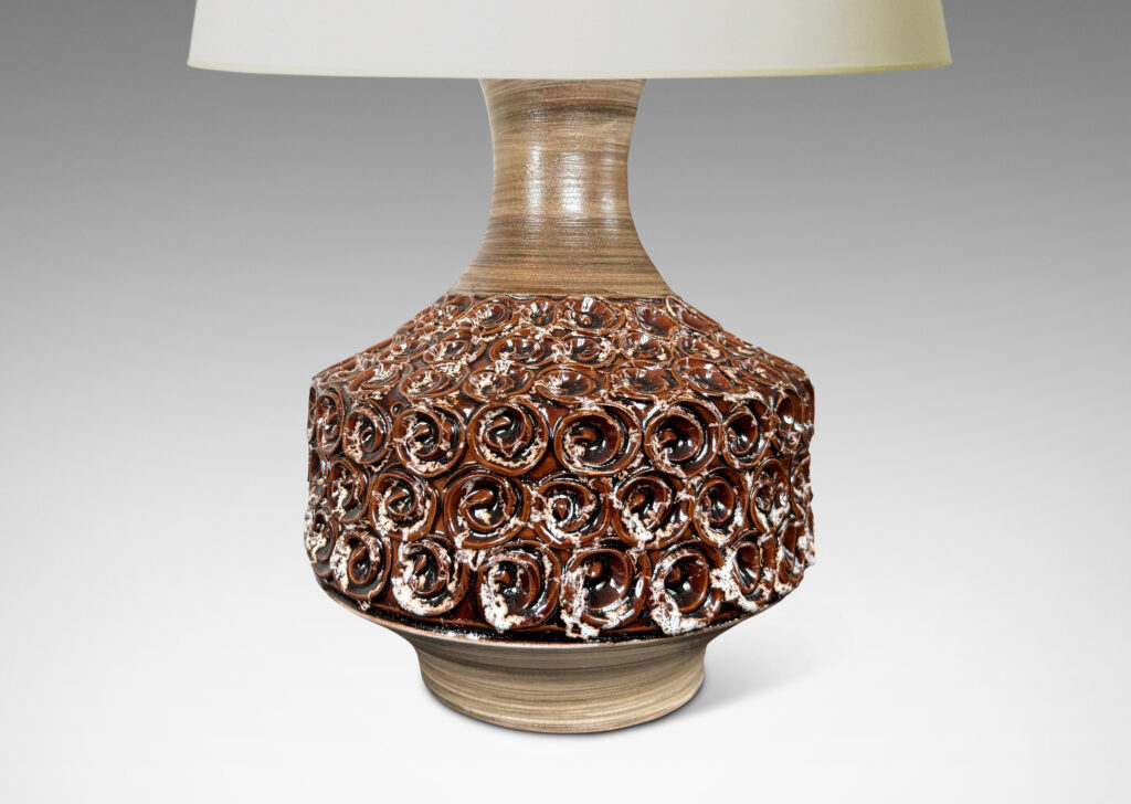 Gallery BAC floating drum form ornamented with swirl motifs glazed in a ganache brown, with sprouting neck and foot glazed in a striae gray-brown