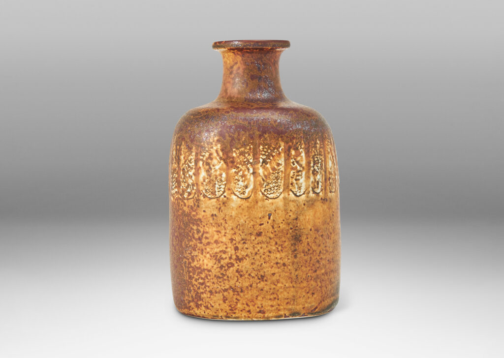 Gallery BAC bottle-like form with compressed cylindrical body and spouting neck, glazed in brown with band of ivory rectangles, all over-glazed with sponged dark brown
