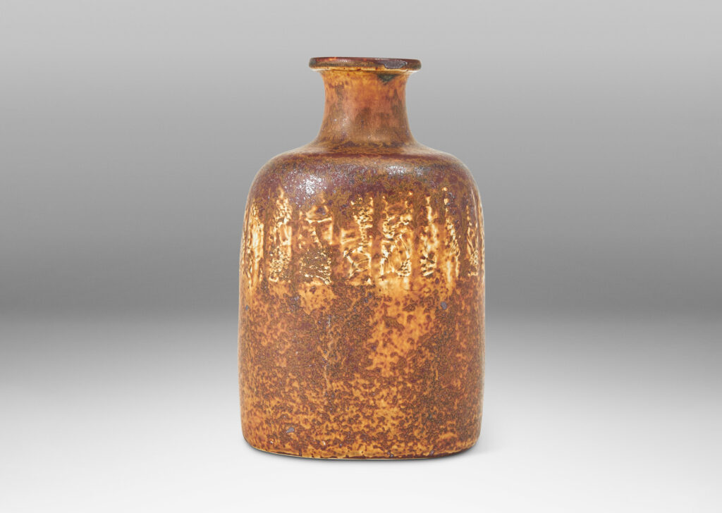 Gallery BAC bottle-like form with compressed cylindrical body and spouting neck, glazed in brown with band of ivory rectangles, all over-glazed with sponged dark brown