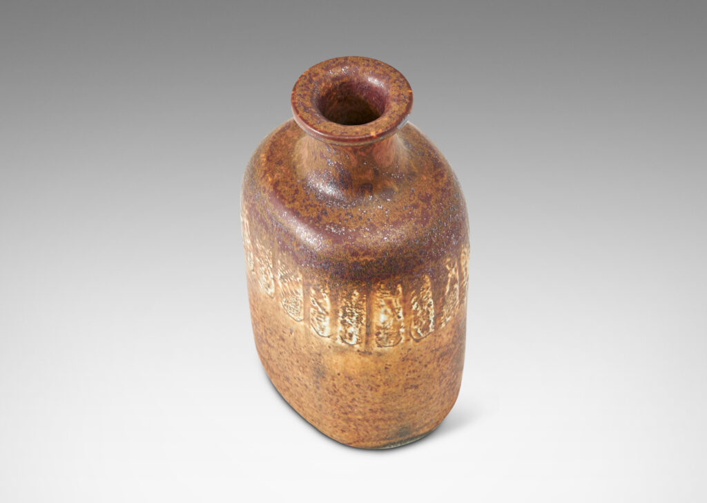 Gallery BAC bottle-like form with compressed cylindrical body and spouting neck, glazed in brown with band of ivory rectangles, all over-glazed with sponged dark brown