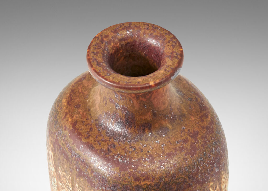 Gallery BAC bottle-like form with compressed cylindrical body and spouting neck, glazed in brown with band of ivory rectangles, all over-glazed with sponged dark brown