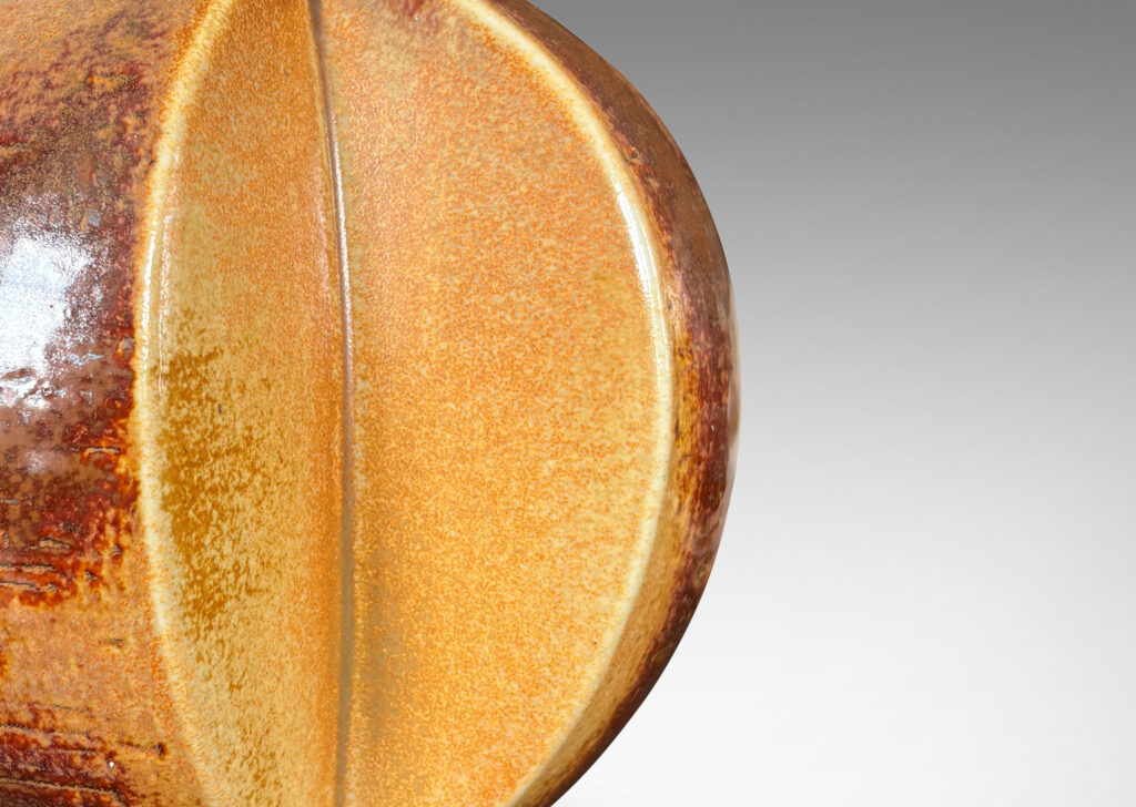 Gallery BAC globe form with wedge slices, glazed in orangey-tan and brown