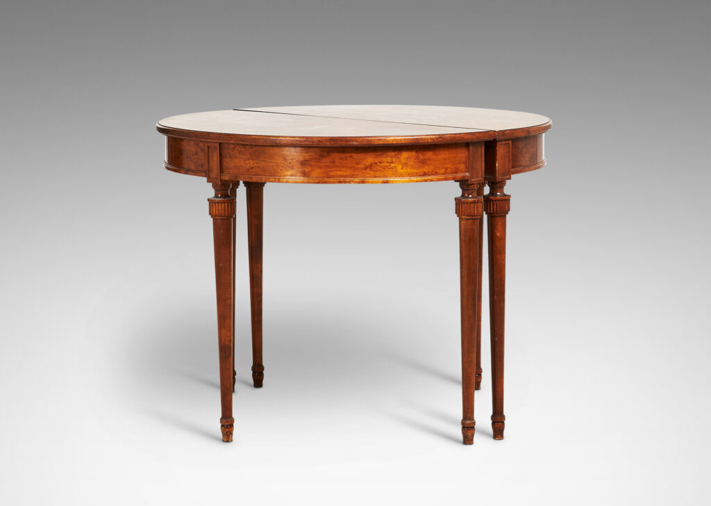 Gallery BAC semi-circular top with checkerboard marquetry and three round tapered legs with stylized tassel headers, which together form a circular table