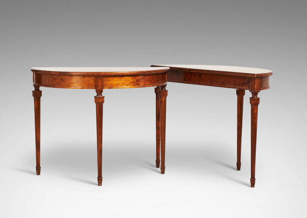 Gallery BAC semi-circular top with checkerboard marquetry and three round tapered legs with stylized tassel headers, which together form a circular table