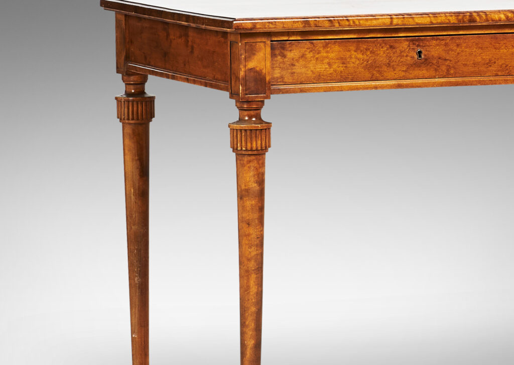 Gallery BAC rectangular top and case with two drawers and round tapered legs with stylized tassel headers