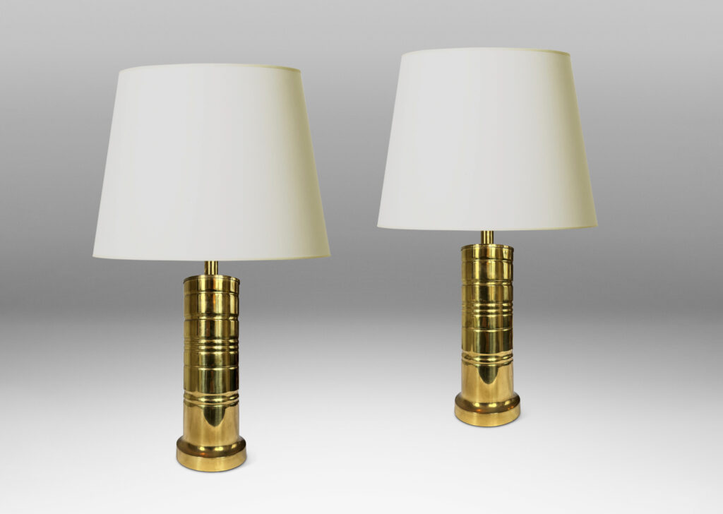 Gallery BAC cylindrical forms with articulated bases and embossed ring details; brass