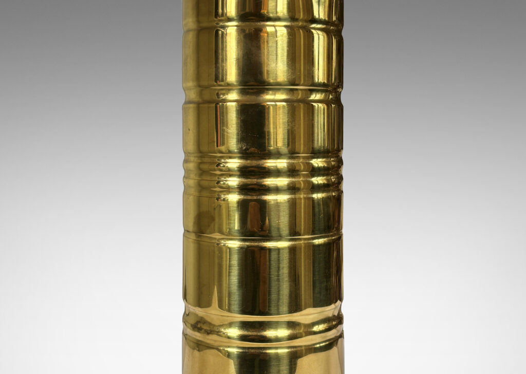Gallery BAC cylindrical forms with articulated bases and embossed ring details; brass