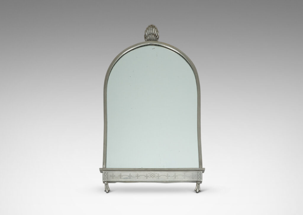 Gallery BAC arched form with shell finial, engraved mantle and foliate brackets; pewter and mirrored glass