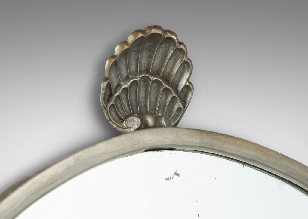 Gallery BAC arched form with shell finial, engraved mantle and foliate brackets; pewter and mirrored glass