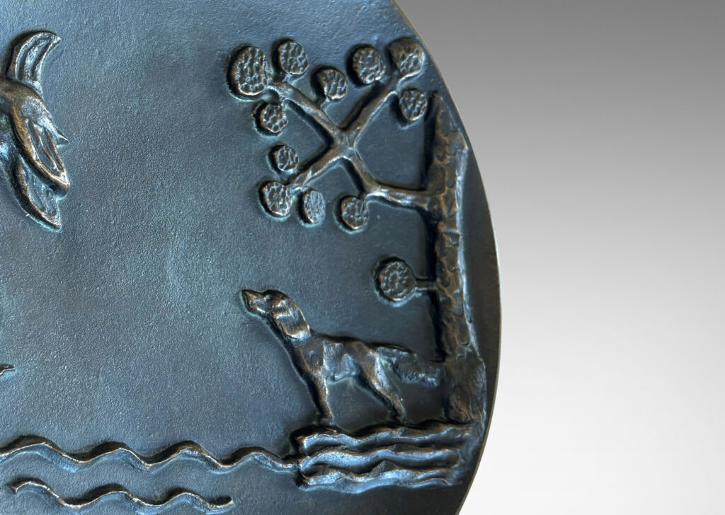 Gallery BAC gently modeled convex round form on a reveal, with relief dog, ducks and stylized landscape; patinated bronze