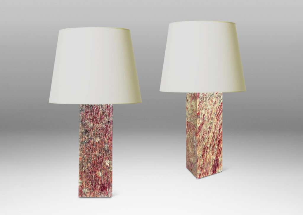 Gallery BAC square pillar forms with carved surface texture in red and gray marble, with cylindrical necks in white marble