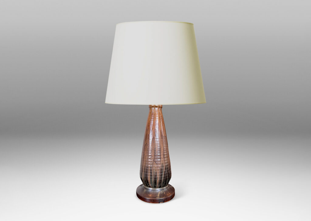 Gallery BAC ridged conical form on a disk plinth, glazed in flowing light, medium and dark browns