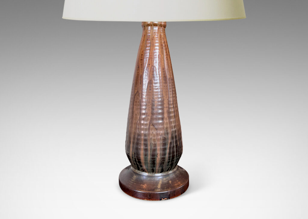 Gallery BAC ridged conical form on a disk plinth, glazed in flowing light, medium and dark browns