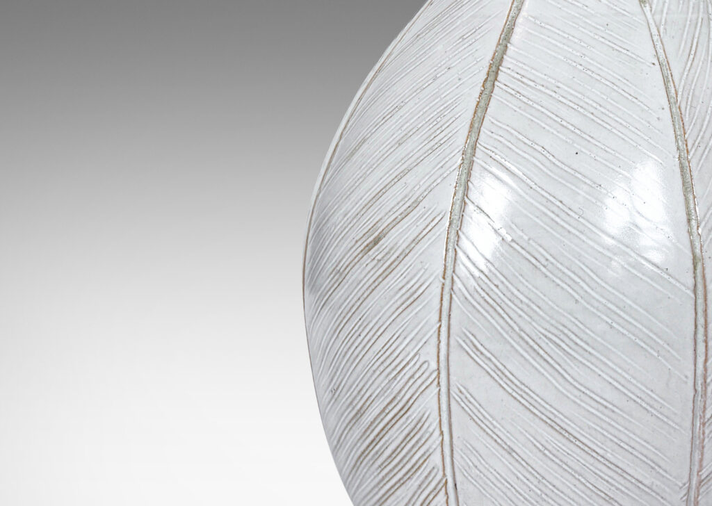 Gallery BAC gourd/drop form finished with carved meridians of herringbone textures and a semi-shiny off-white glaze