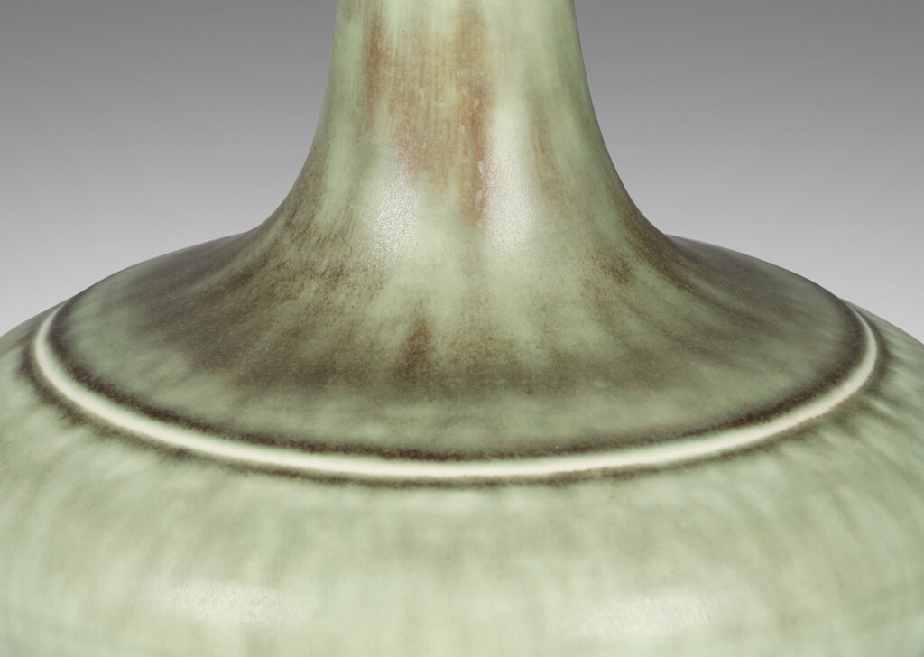 Gallery BAC decanter-like form with a wide compressed base and sprouting neck; glazed in a flowing blue-green and gray
