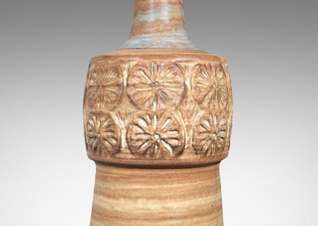 Gallery BAC tapered column forms capped with rosette motifs, glazed in a striae brown over tan