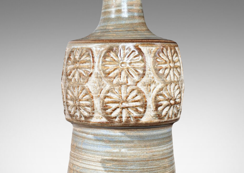 Gallery BAC tapered column forms capped with rosette motifs, glazed in a striae brown over tan