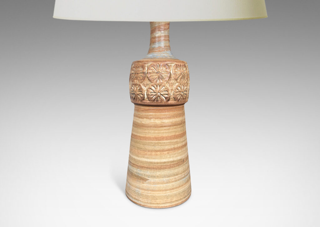 Gallery BAC tapered column forms capped with rosette motifs, glazed in a striae brown over tan