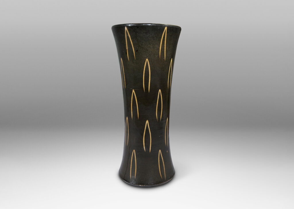 Gallery BAC gently trumpeting form glazed dark brown, with sgraffito leaf motifs