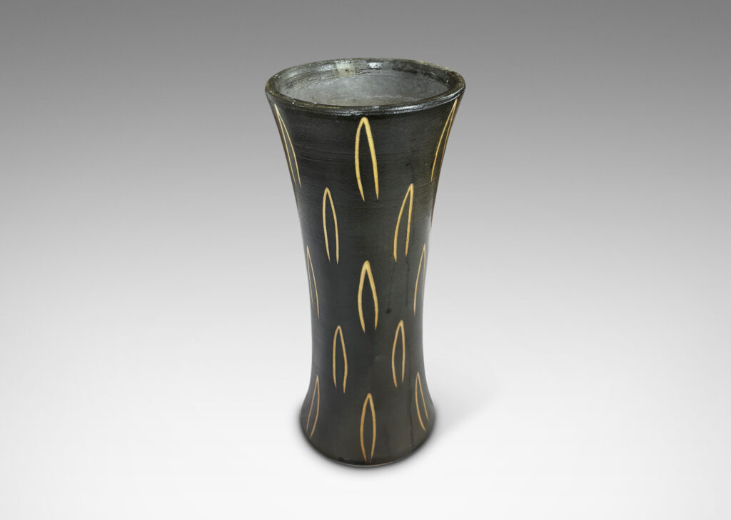 Gallery BAC gently trumpeting form glazed dark brown, with sgraffito leaf motifs