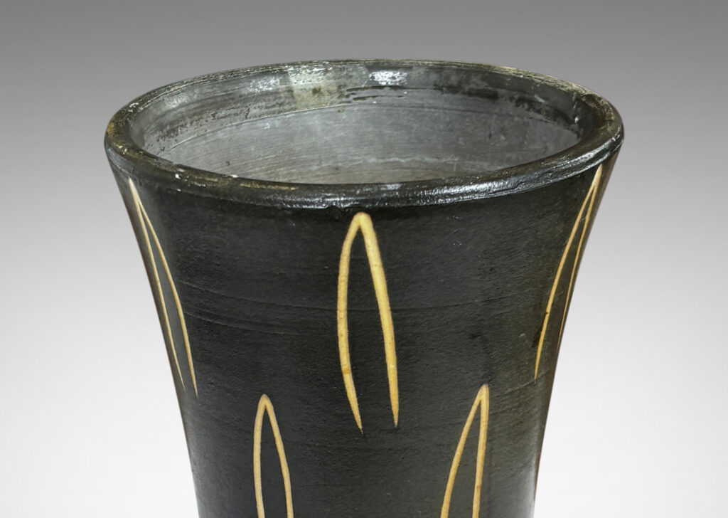 Gallery BAC gently trumpeting form glazed dark brown, with sgraffito leaf motifs