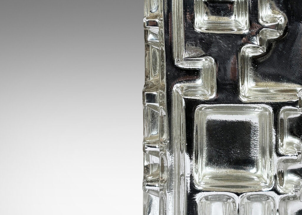 Gallery BAC square pillar form with muscular geometric reliefs and silvered backing; mirrored mold-blown glass