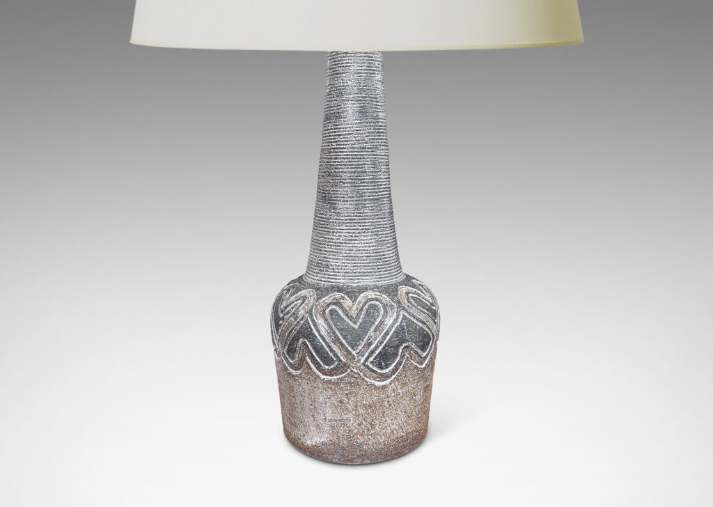 Gallery BAC tapered drum form with carved band of alternating heart motifs, and tall ridged conical neck, glazed in matte dark and light browns