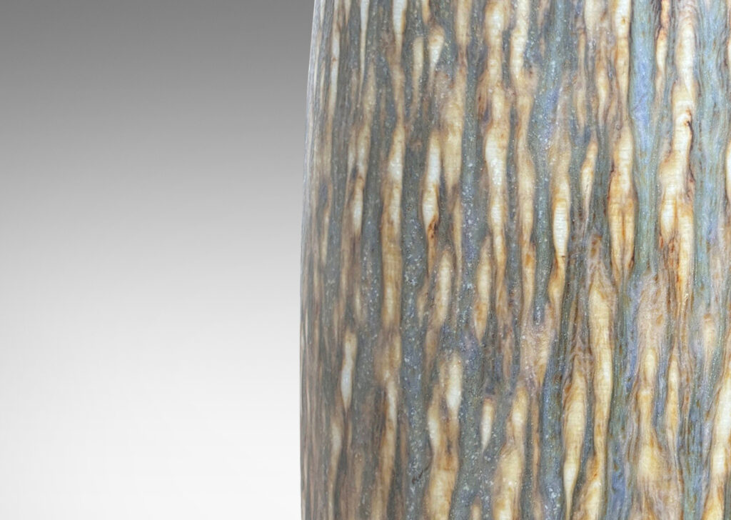 Gallery BAC swelling cylindrical form with carved gouged surface and flowing brown glaze