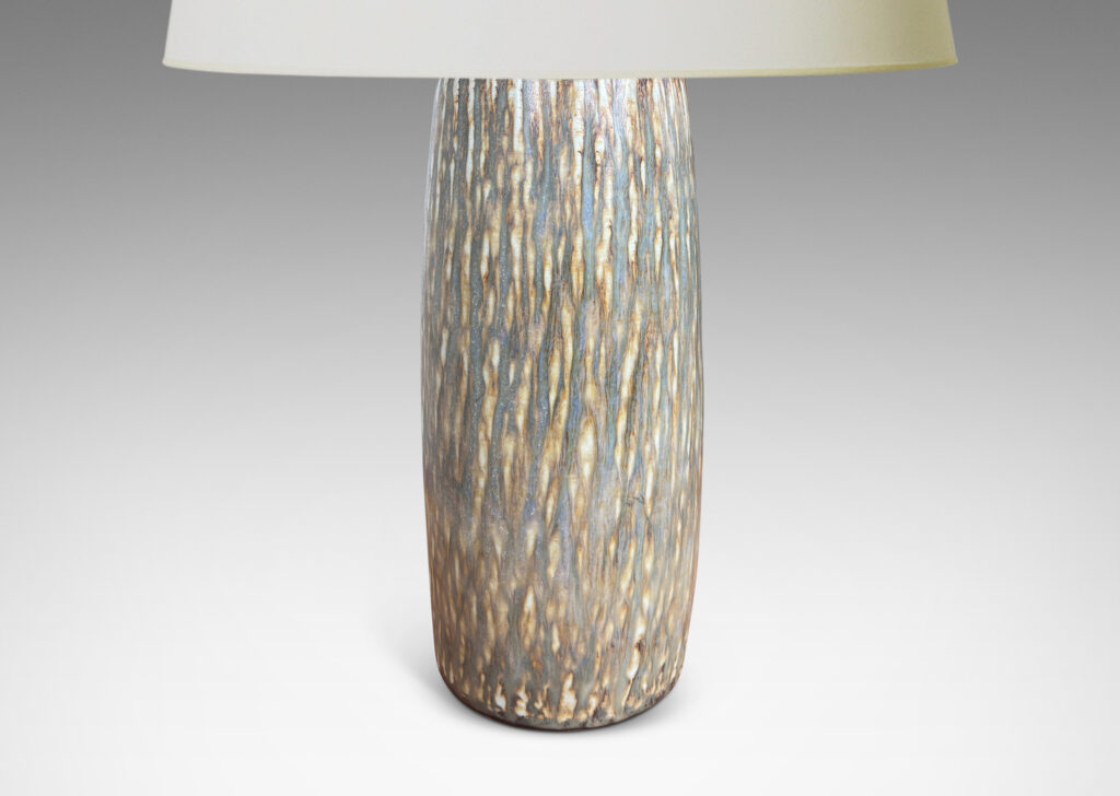 Gallery BAC swelling cylindrical form with carved gouged surface and flowing brown glaze