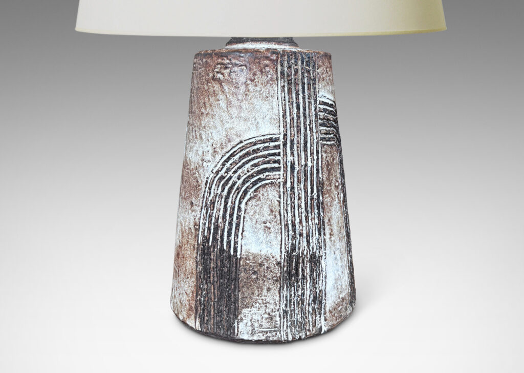 Gallery BAC squared bulb form with attenuated neck and carved concentric drop design, glazed in pale gray-tan and brown