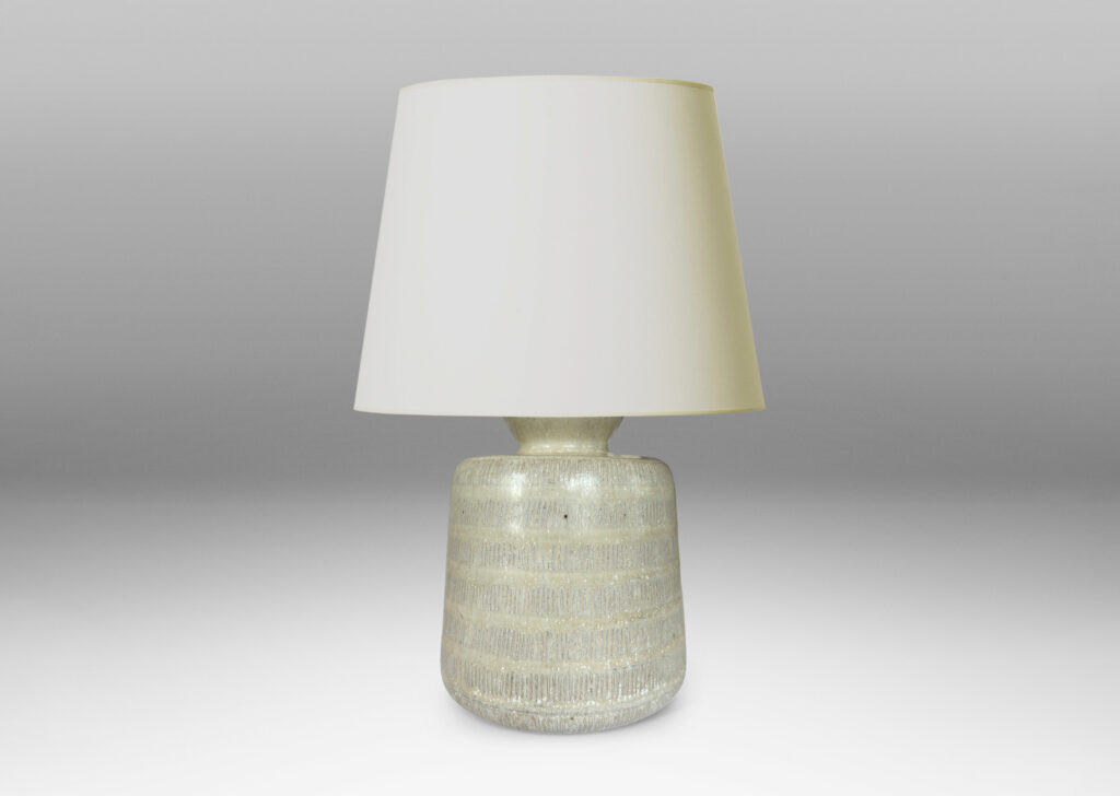 Gallery BAC upwardly tapered cylindrical form with bands of carved strikes; glazed in a dappled oyster / pale gray