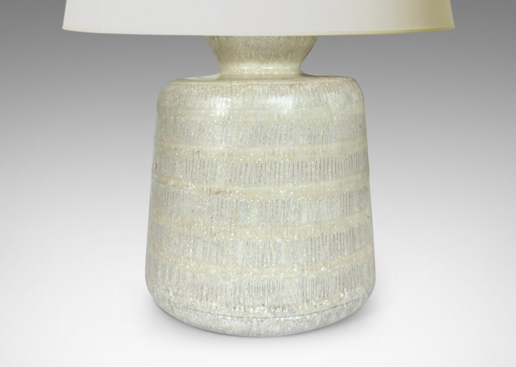 Gallery BAC upwardly tapered cylindrical form with bands of carved strikes; glazed in a dappled oyster / pale gray