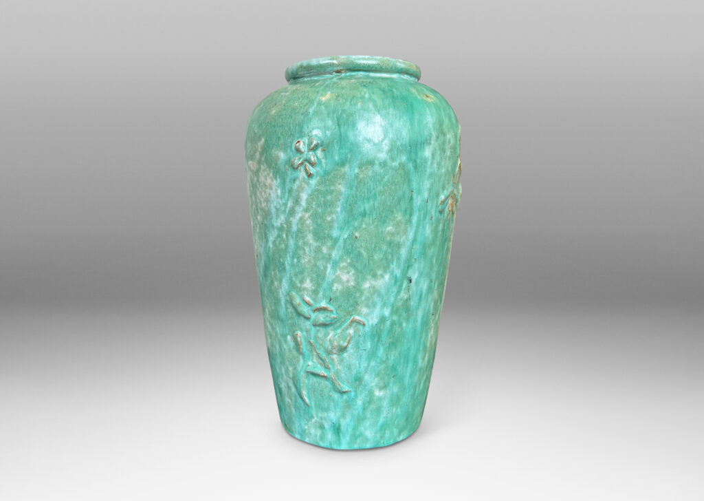 Gallery BAC tall tapered form with floating floral motifs in relief, glazed in a flowing bright celadon green