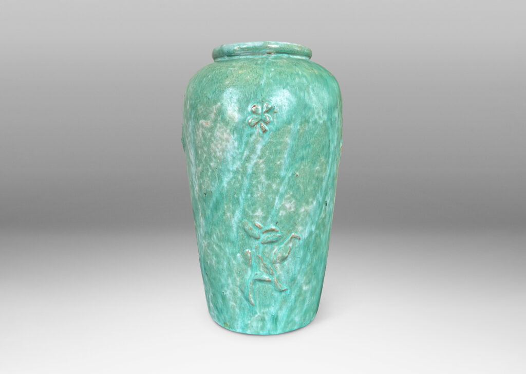 Gallery BAC tall tapered form with floating floral motifs in relief, glazed in a flowing bright celadon green