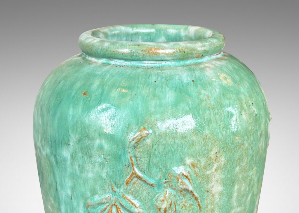 Gallery BAC tall tapered form with floating floral motifs in relief, glazed in a flowing bright celadon green