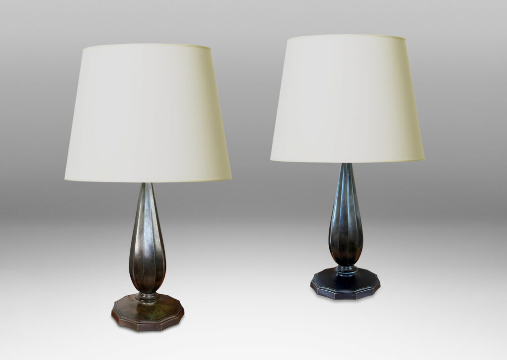 Gallery BAC fluted drop forms on disk plinths with fluted edges, finished in dark bronze tones