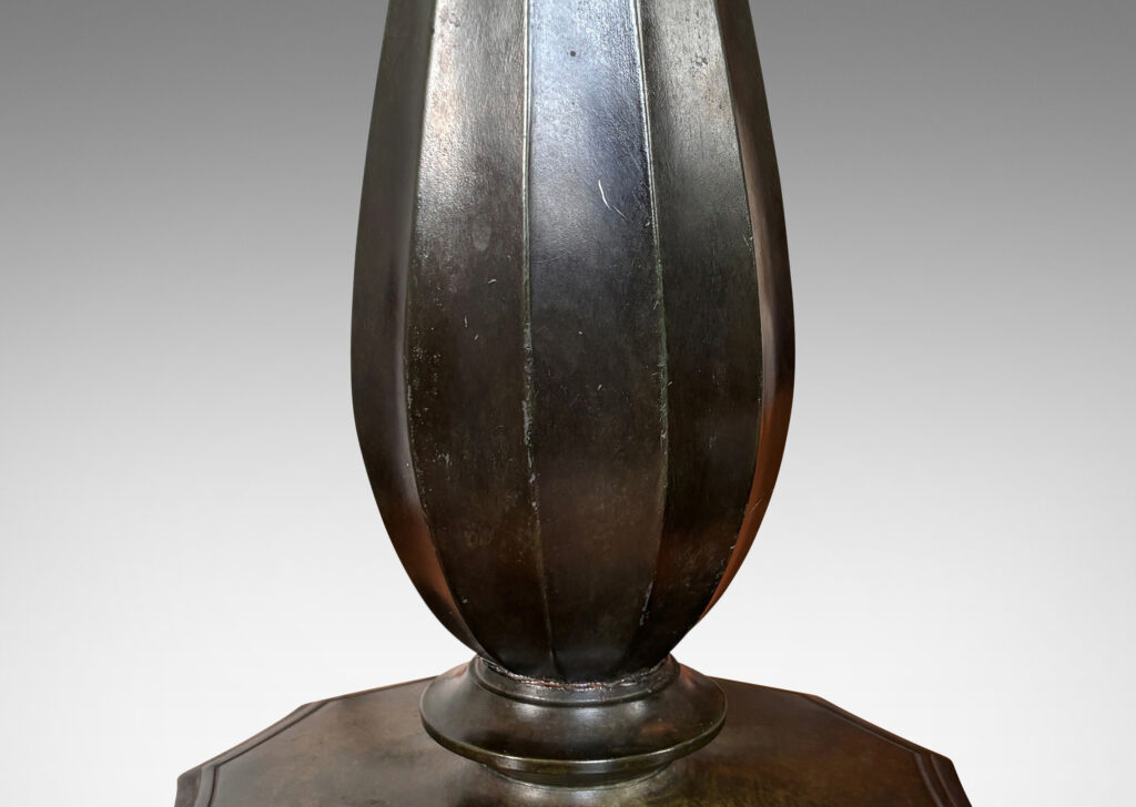 Gallery BAC fluted drop forms on disk plinths with fluted edges, finished in dark bronze tones