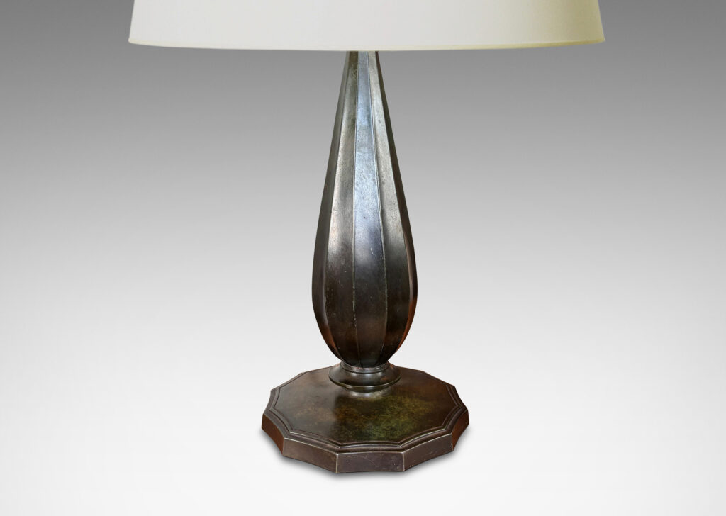 Gallery BAC fluted drop forms on disk plinths with fluted edges, finished in dark bronze tones